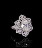 Angled top view showing geometric symmetry of starburst floral halo and oval stone.