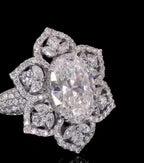 High-detail close-up shot of 3 CT oval lab diamond and micro-pave petal borders.