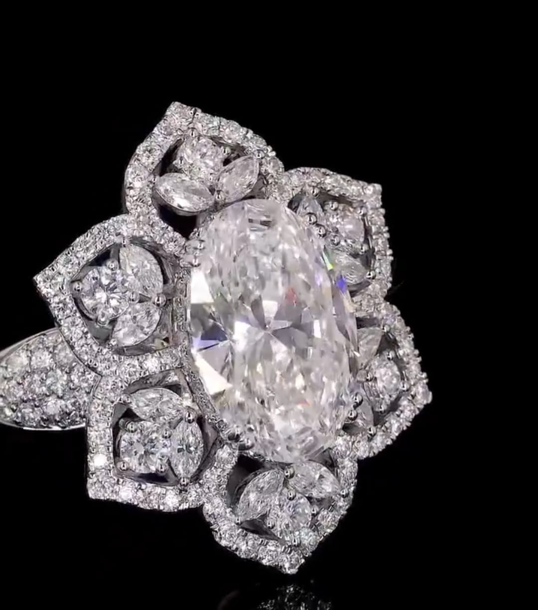 High-detail close-up shot of 3 CT oval lab diamond and micro-pave petal borders.