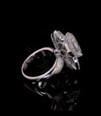 Side view highlighting high-set floral setting support and polished white gold shank.