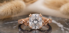 Top view of 3 CT cushion cut lab grown diamond in a rose gold double claw prong setting.