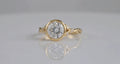 Front reflection view of 3 CT round lab grown diamond bezel ring in yellow gold.