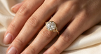 Close-up on-hand photo of 3 CT round lab diamond bezel engagement ring with twisted band.