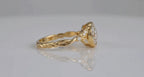 Side profile view showing twisted rope shank and bezel setting profile of yellow gold ring.