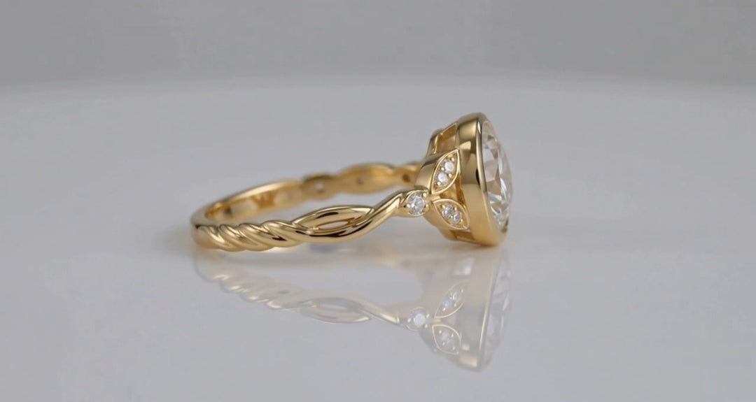 Side profile view showing twisted rope shank and bezel setting profile of yellow gold ring.