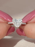 Face-up top view of a brilliant 2 CT heart cut lab grown diamond center stone on a micro-pavé band