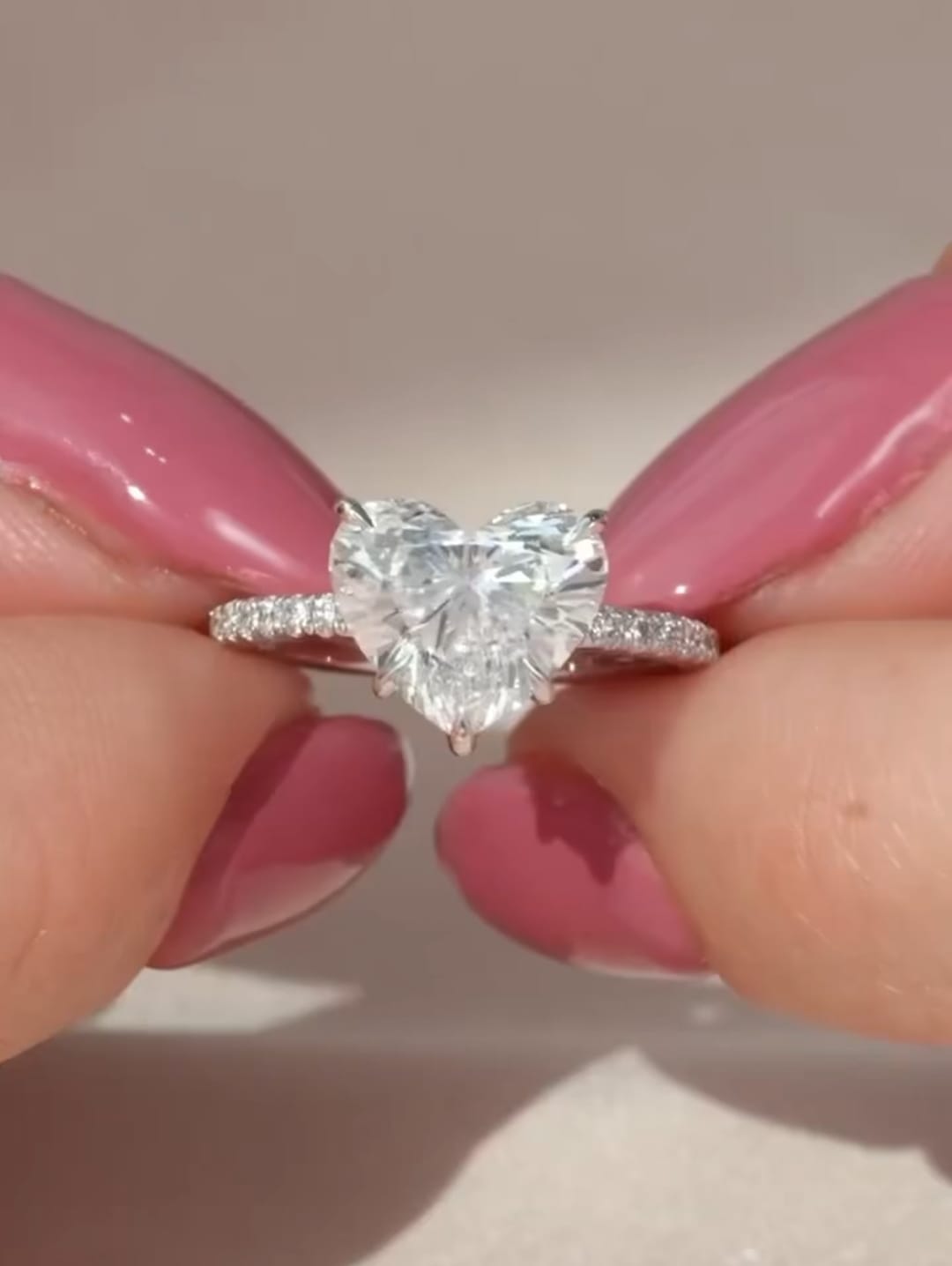 Face-up top view of a brilliant 2 CT heart cut lab grown diamond center stone on a micro-pavé band