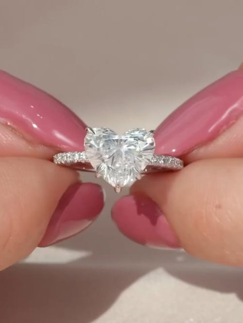 Face-up top view of a brilliant 2 CT heart cut lab grown diamond center stone on a micro-pavé band