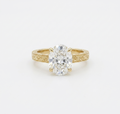 Top-down view of 4 CT oval cut lab grown diamond in yellow gold claw prong setting.