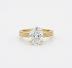 Top-down view of 4 CT oval cut lab grown diamond in yellow gold claw prong setting.