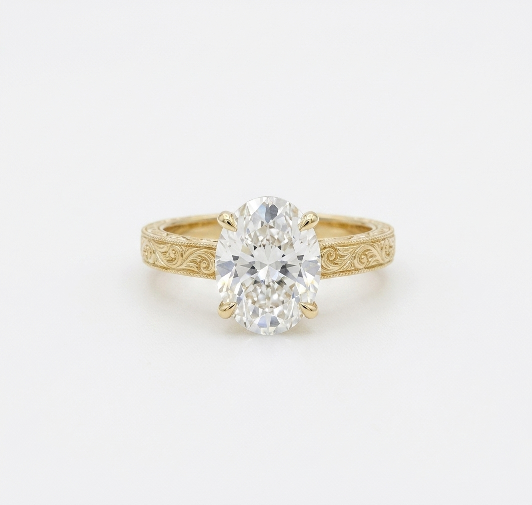 Top-down view of 4 CT oval cut lab grown diamond in yellow gold claw prong setting.