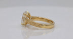Profile perspective showing intricate hand-carved filigree scrollwork on yellow gold shank.