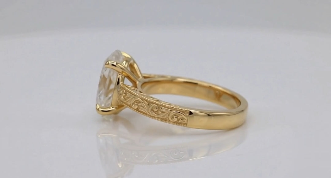 Profile perspective showing intricate hand-carved filigree scrollwork on yellow gold shank.