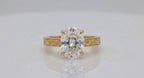 Direct front view of 4 CT oval lab diamond solitaire ring on reflective white background.