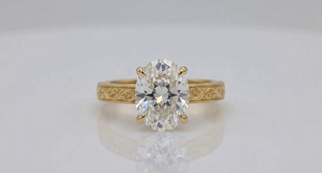 Direct front view of 4 CT oval lab diamond solitaire ring on reflective white background.