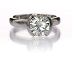 Front view of a 2 CT round lab grown diamond ring in a half-bezel white gold solitaire setting.
