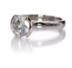 Perspective angled view highlighting the light-capturing open side profile of the half-bezel ring setting.