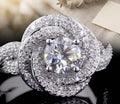 Top-down close-up view of a 2 CT round lab grown diamond surrounded by a swirling pave halo frame.