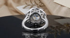 Bottom-up view highlighting the architectural lattice gallery of a white gold 2 CT round halo ring.