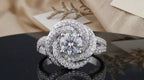 Front perspective shot showcasing the complete swirl halo design holding a 2 CT round lab diamond.