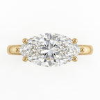 Top-down view of a 3 CT marquise cut lab diamond set horizontally in an East-West yellow gold ring.