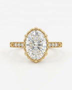 Top-down view of a 4 CT oval lab grown diamond ring in a scalloped yellow gold crown setting with accent diamonds.