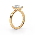 Side profile view showing the basket setting and double-rail shank of a yellow gold 4 CT oval ring.