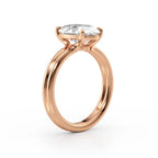 Side profile shot of a 4 CT oval lab grown diamond ring on a rose gold double-wire band.