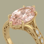 Close-up angle view highlighting six-prong setting and undergallery scrollwork of a fancy pink marquise diamond ring.