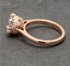 Side profile view showing the intricate milgrain filigree and micro-pavé diamond basket under the center round stone.
