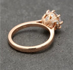Side view highlighting the smooth polished rose gold band and detailed pavé crown basket setting.