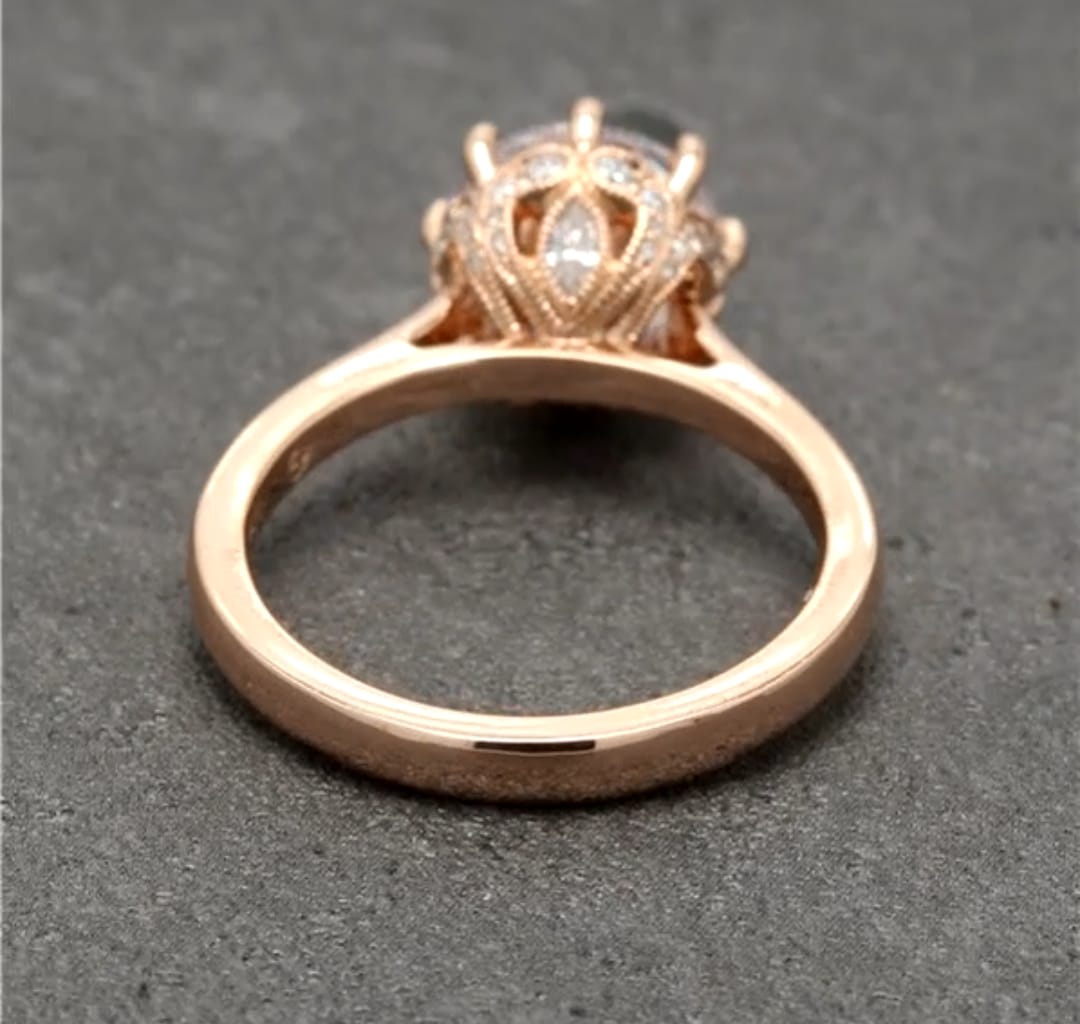 Under-gallery view detailing the micro-pavé leaf-patterned crown setting resting on a rose gold ring band.