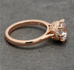 High-angle side view showcasing the cathedral transition to the pave-detailed crown basket in rose gold.