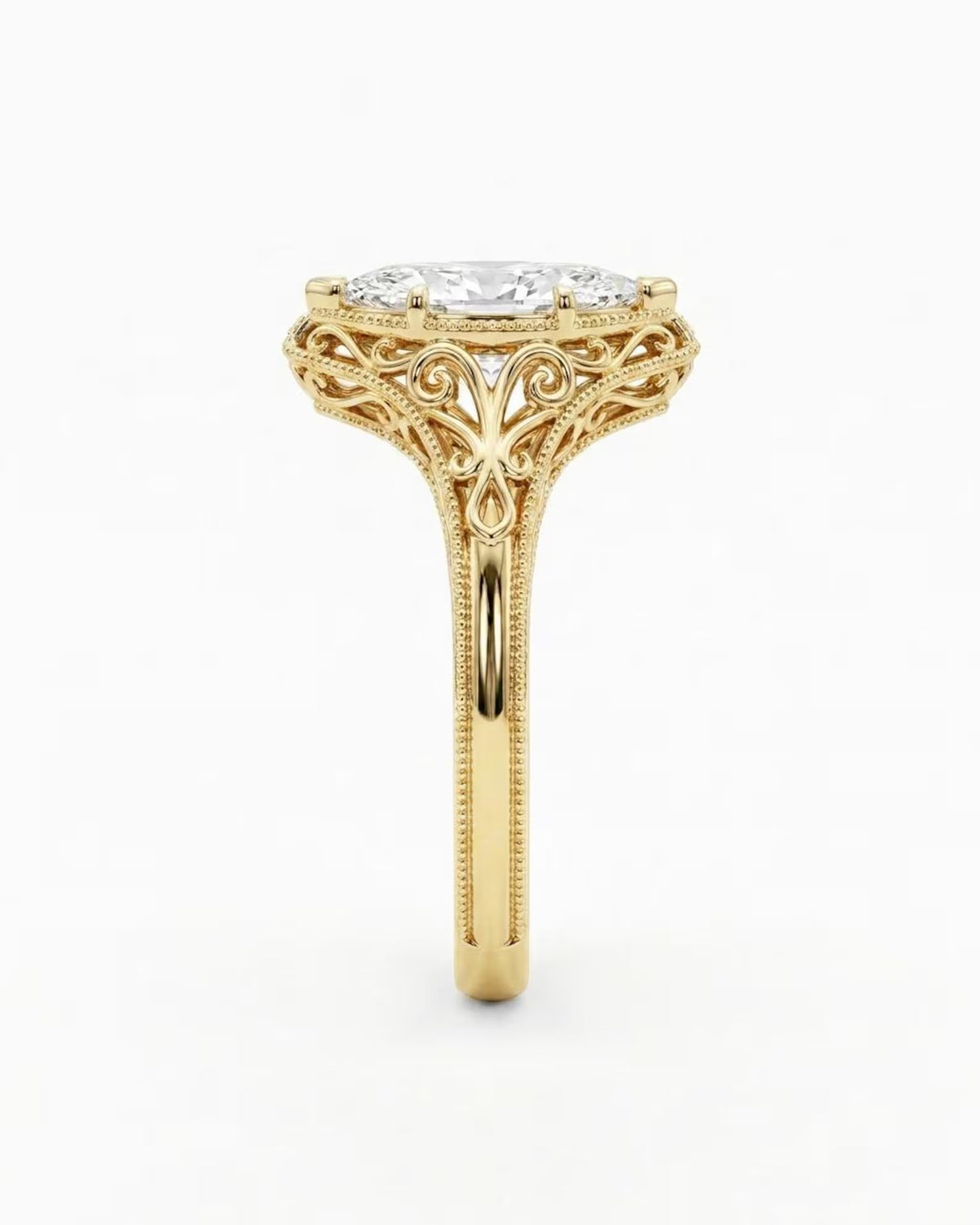 Side profile view of a 4 CT marquise lab grown diamond ring showing yellow gold openwork scrollwork undergallery.