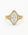 Top-down view of a 4 CT marquise cut lab grown diamond in a vintage milgrain filigree frame.