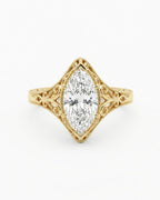 Top-down view of a 4 CT marquise cut lab grown diamond in a vintage milgrain filigree frame.