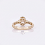 Interior and gallery view of a 3 CT oval lab grown diamond ring with hand-carved band pattern and hidden halo in 14K yellow gold.
