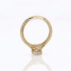 Side profile view of a yellow gold 3 CT oval lab diamond engagement ring showing filigree scrollwork and a bezel-set bridge accent diamond.