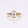 Direct top view of a 3 CT oval cut lab grown diamond engagement ring with split diamond shoulders and detailed hand-engraved band.