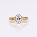 Direct top view of a 3 CT oval cut lab grown diamond engagement ring with split diamond shoulders and detailed hand-engraved band.