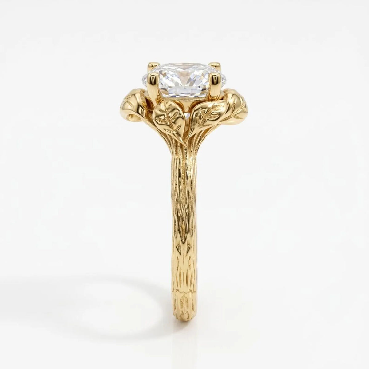 Side profile of a 4 CT round cut lab grown diamond ring in yellow gold featuring an organic bark-textured shank and sculpted leaf prongs.