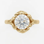 Direct overhead view showing the facet pattern of a 4 CT round brilliant cut lab diamond surrounded by yellow gold leaves.