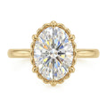 Top-down view of a 3 CT oval cut lab grown diamond in a scalloped fluted yellow gold setting.