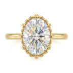 Top-down view of a 3 CT oval cut lab grown diamond in a scalloped fluted yellow gold setting.