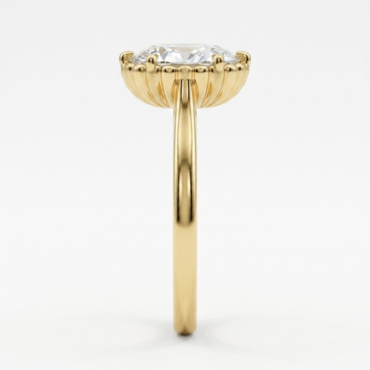 Side profile of a 3 carat oval lab diamond engagement ring showing the detailed fluted cup gallery in yellow gold.