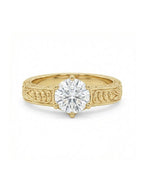 Top-down view of a 3 CT round cut lab grown diamond engagement ring in a 6-prong yellow gold setting with hand-carved scrollwork band.