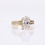 Front view of a 3 CT marquise cut lab grown diamond engagement ring in yellow gold featuring a split shank with pavé diamond center row.