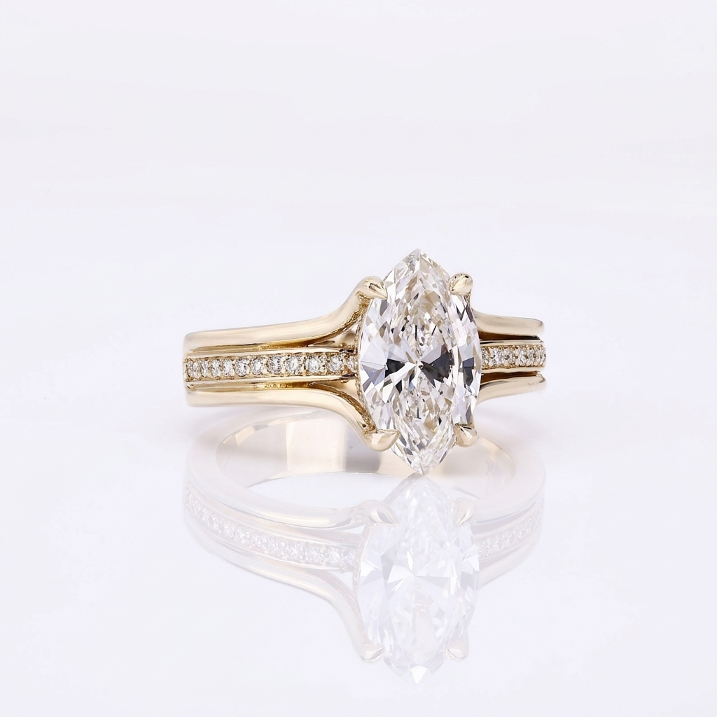 Front view of a 3 CT marquise cut lab grown diamond engagement ring in yellow gold featuring a split shank with pavé diamond center row.