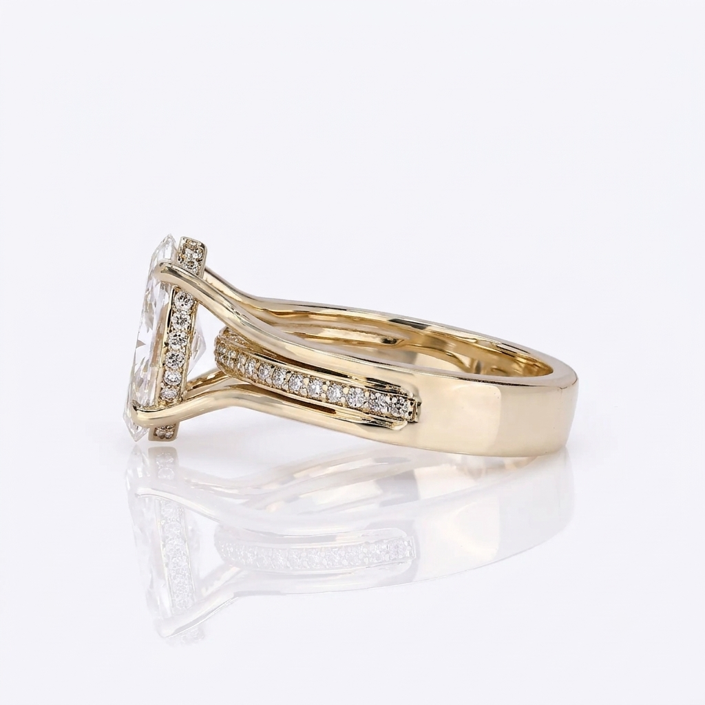 Three-quarter angle showing the elevated marquise center diamond and embedded pavé accent row.