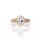 Direct top-down view of a 3 carat marquise cut lab created diamond set on a yellow gold split pavé band.